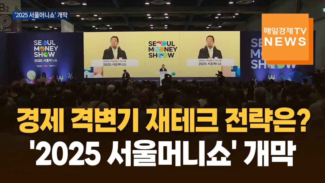 많은 관중이 모인 행사장에서 '2025 서울머니쇼' 개막식이 진행되고 있으며, 무대 위 연사가 대형 스크린에 비치고 있다. 화면에는 '경제 격변기 재테크 전략은? 2025 서울머니쇼 개막'이라는 문구가 크게 보인다.